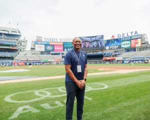 Alumni standing on baseball field